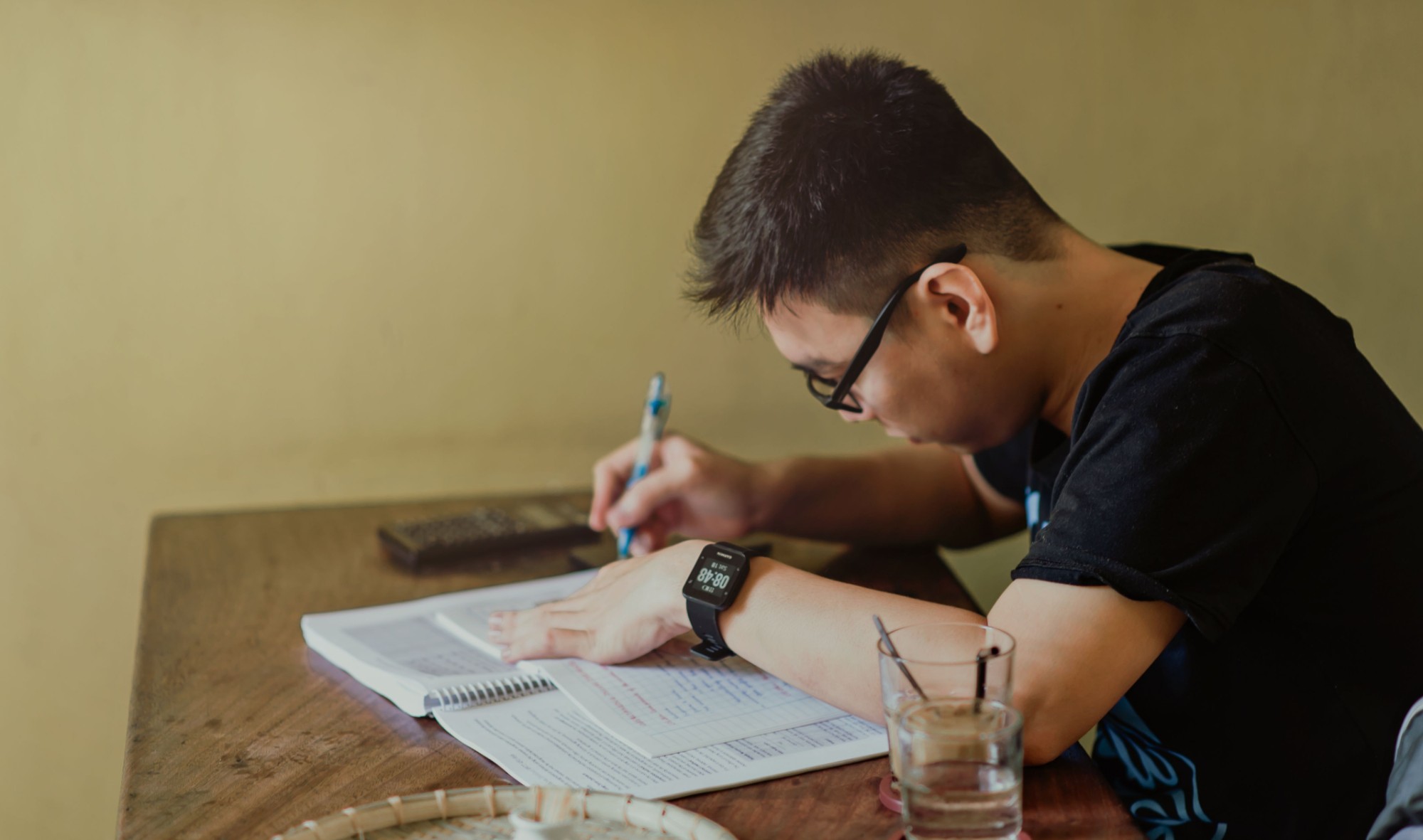 A student taking notes while practising for the CCL test